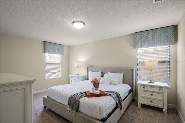 carpeted bedroom featuring a textured ceiling