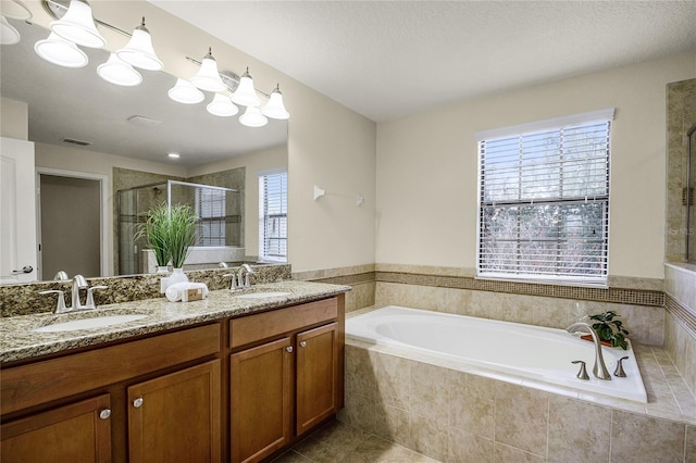 bathroom with tile patterned floors, vanity, and independent shower and bath