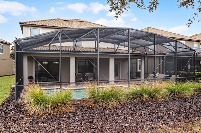 back of property featuring a lanai