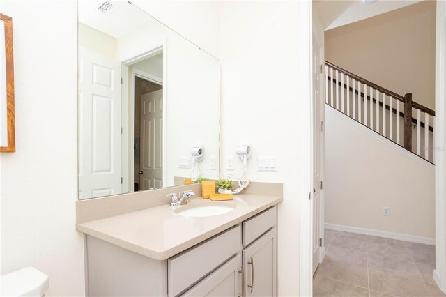 bathroom featuring tile patterned floors, vanity, and toilet