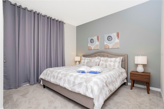 bedroom featuring light colored carpet