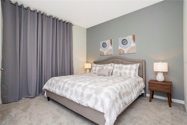 bedroom featuring light colored carpet