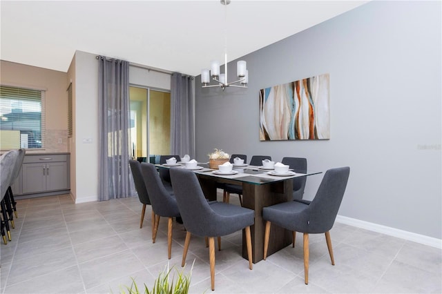 dining room featuring an inviting chandelier and light tile patterned flooring