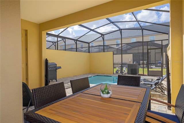 view of pool with a patio, a lanai, a grill, and central AC