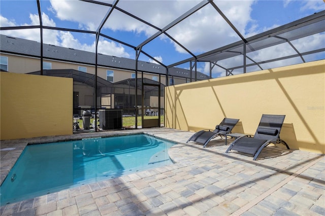 view of pool featuring a lanai, central AC unit, and a patio area