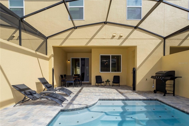 back of property featuring a patio area and glass enclosure