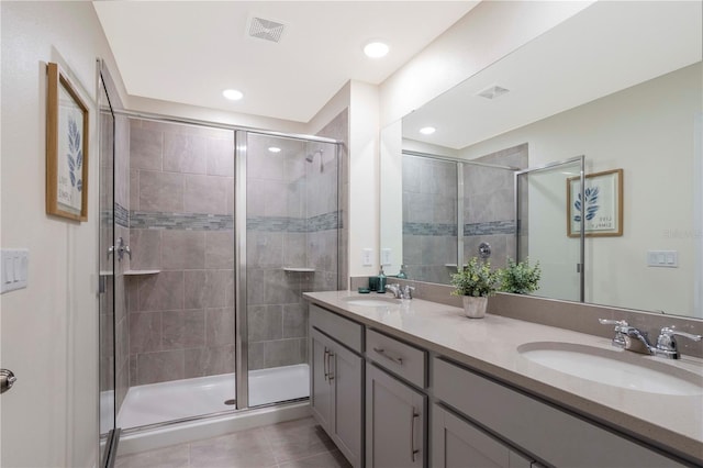 bathroom featuring vanity, an enclosed shower, and tile patterned flooring