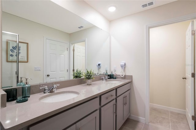 bathroom featuring tile patterned flooring and vanity