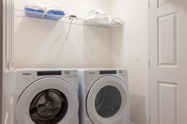 clothes washing area featuring separate washer and dryer