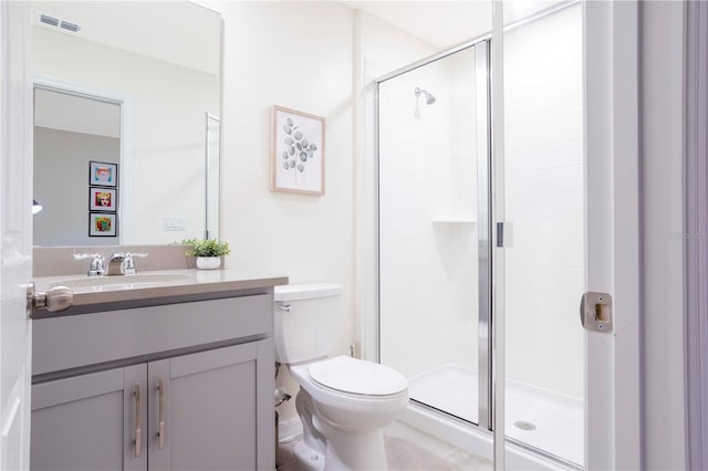 bathroom featuring vanity, an enclosed shower, and toilet