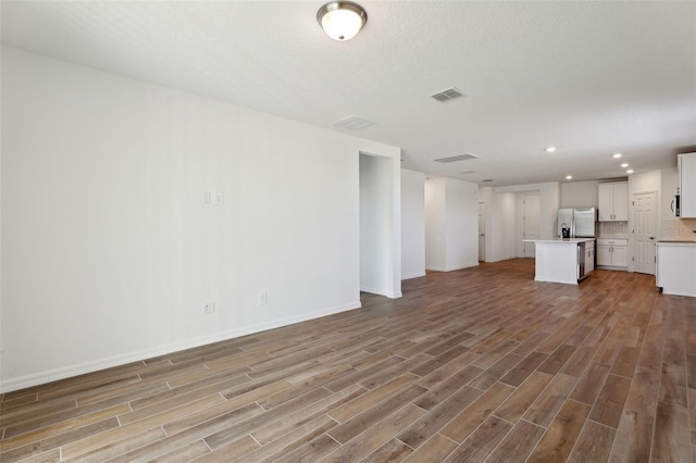 unfurnished living room featuring hardwood / wood-style flooring