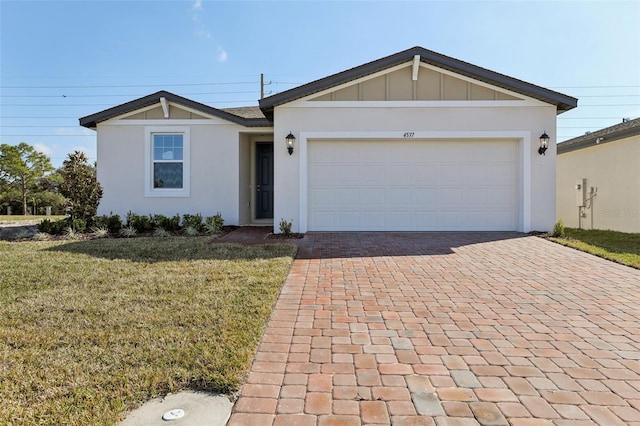 single story home featuring a garage and a front lawn