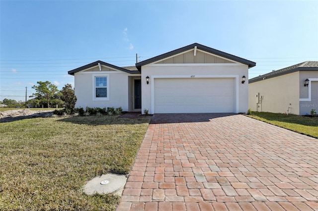 ranch-style house featuring a garage and a front lawn