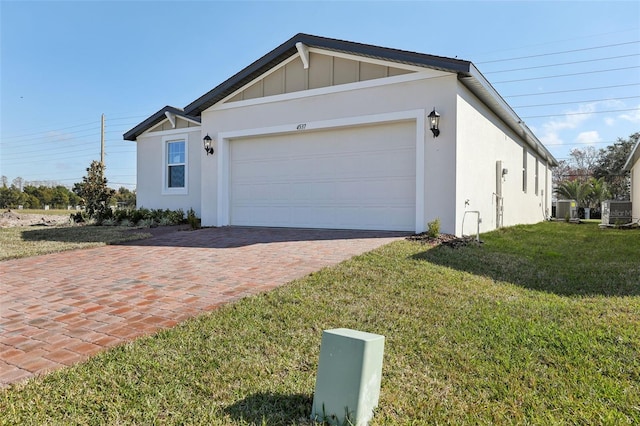 view of front of house with a garage, a front lawn, and central air condition unit