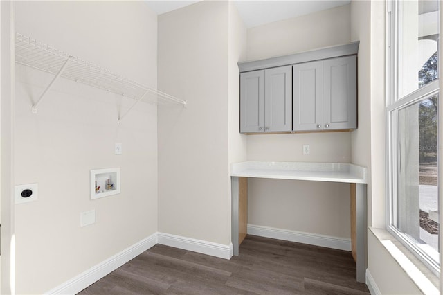 laundry area featuring hookup for a washing machine, dark hardwood / wood-style flooring, hookup for an electric dryer, and cabinets