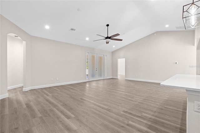 unfurnished living room featuring light hardwood / wood-style flooring, ceiling fan, and vaulted ceiling