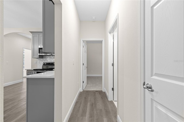 corridor with light hardwood / wood-style floors