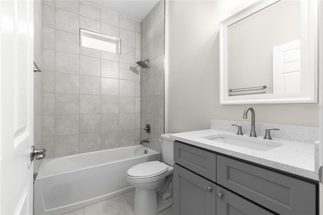 full bathroom featuring vanity, tile patterned floors, toilet, and tiled shower / bath