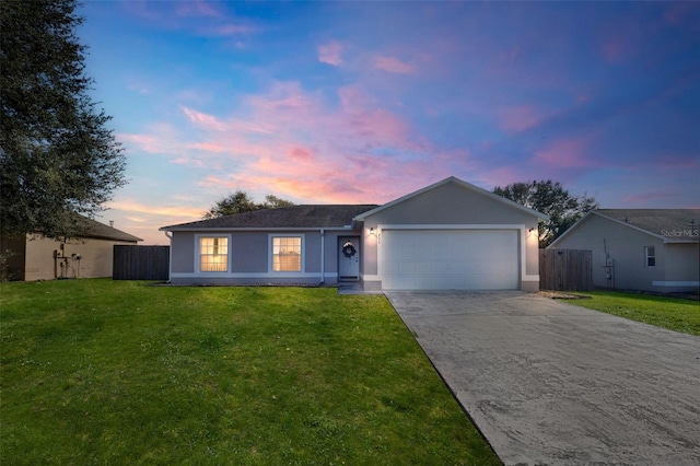 single story home with a yard and a garage