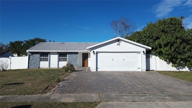 single story home featuring a garage and a front yard