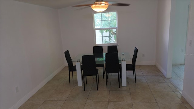 tiled dining space featuring ceiling fan