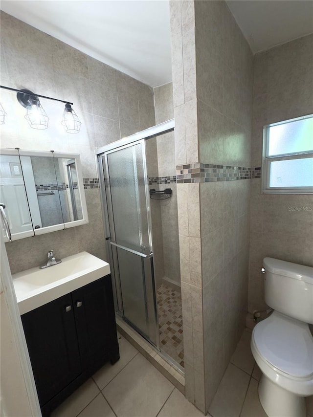 bathroom with tile walls, tile patterned floors, toilet, and walk in shower