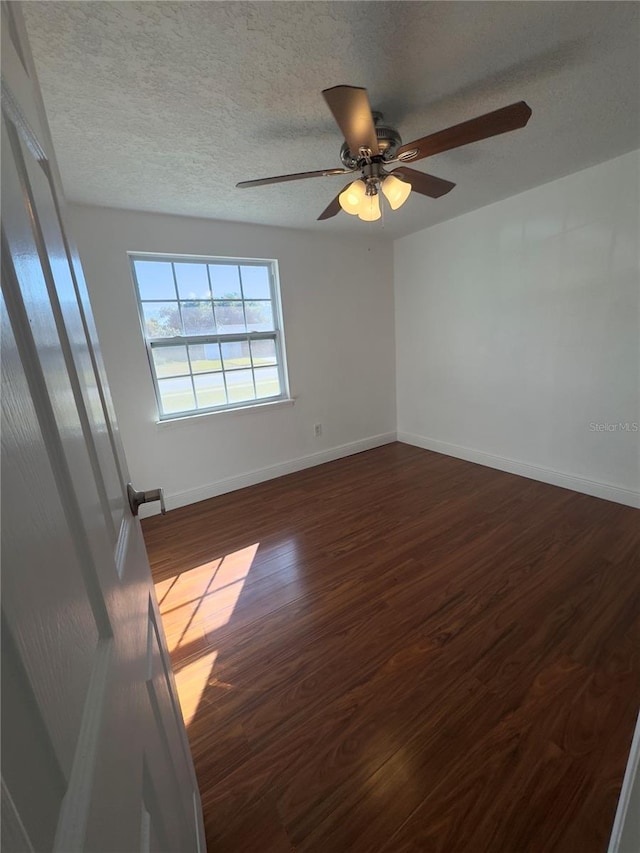 unfurnished room featuring hardwood / wood-style flooring and a textured ceiling