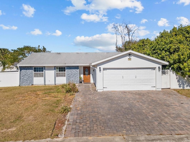 ranch-style house with a garage and a front yard