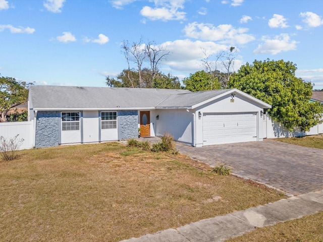 ranch-style home featuring a garage and a front lawn