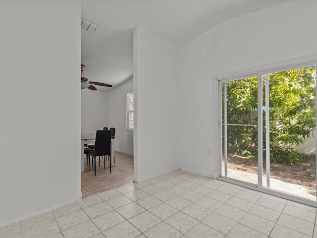 tiled empty room with vaulted ceiling and ceiling fan