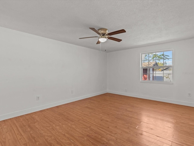 empty room featuring ceiling fan, a textured ceiling, and light hardwood / wood-style flooring