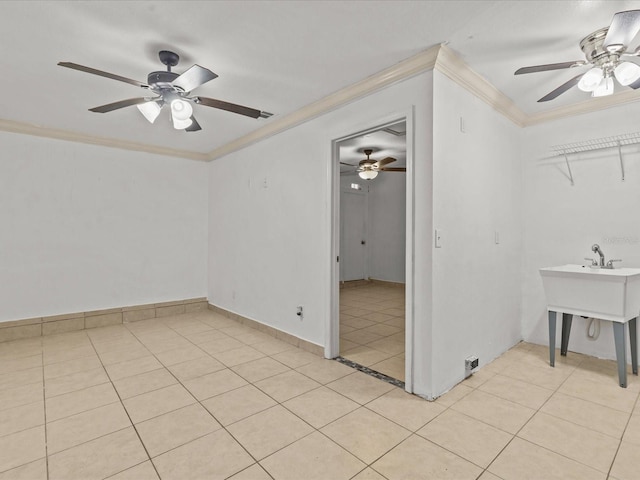 spare room featuring crown molding, light tile patterned floors, and ceiling fan