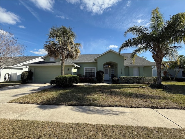 ranch-style home with a garage and a front lawn