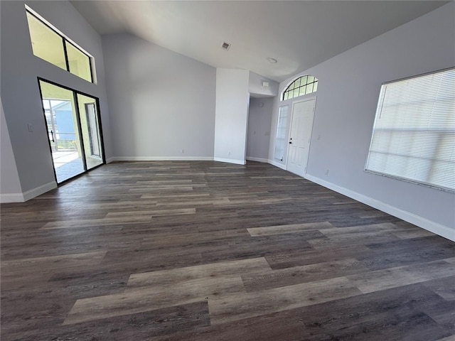 empty room featuring lofted ceiling and dark hardwood / wood-style flooring