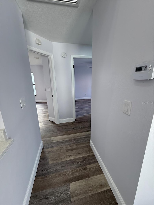 hallway featuring dark hardwood / wood-style flooring