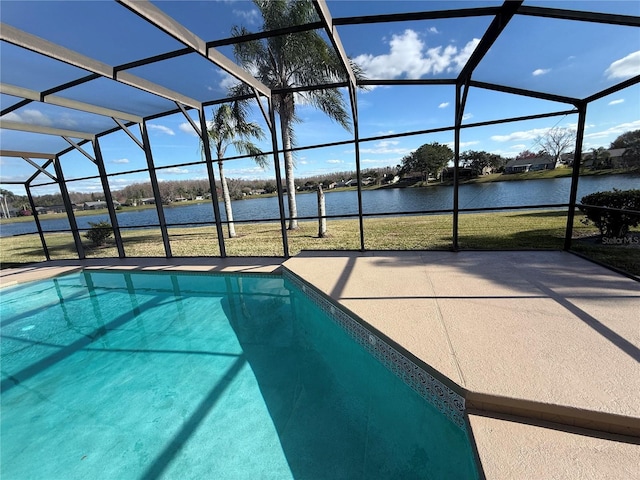 view of swimming pool with a patio, a water view, and glass enclosure