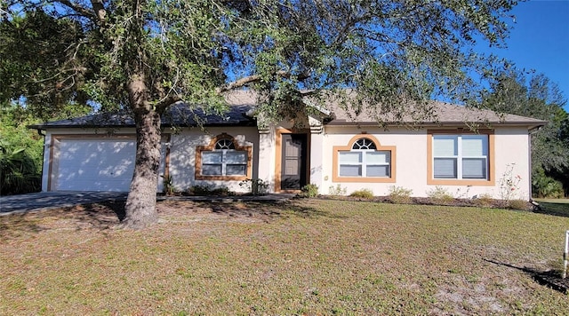 ranch-style house with a garage and a front lawn