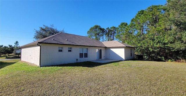 back of house with a lawn