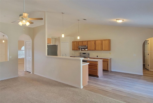 kitchen with decorative light fixtures, an island with sink, lofted ceiling, exhaust hood, and stainless steel appliances