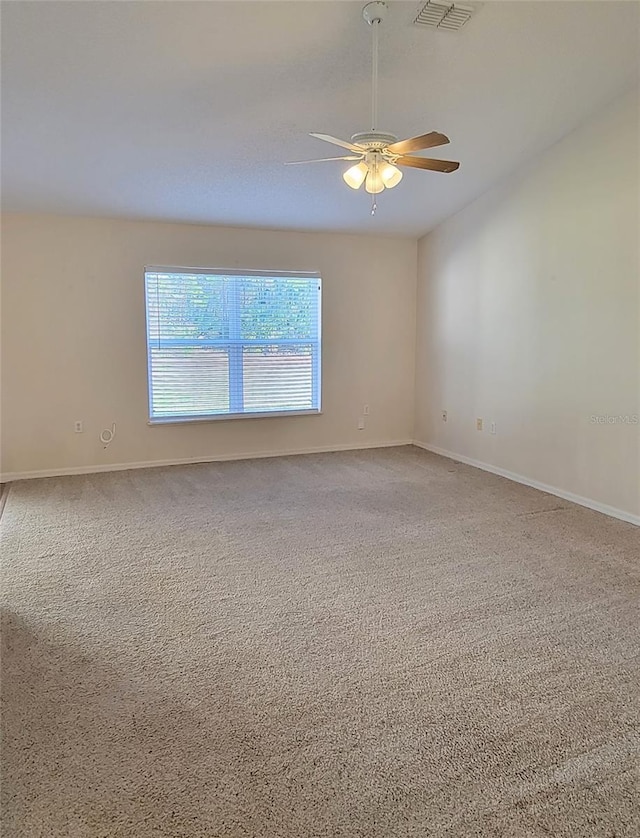 carpeted empty room featuring ceiling fan