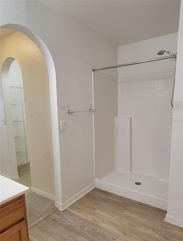 bathroom with vanity, hardwood / wood-style floors, and a shower