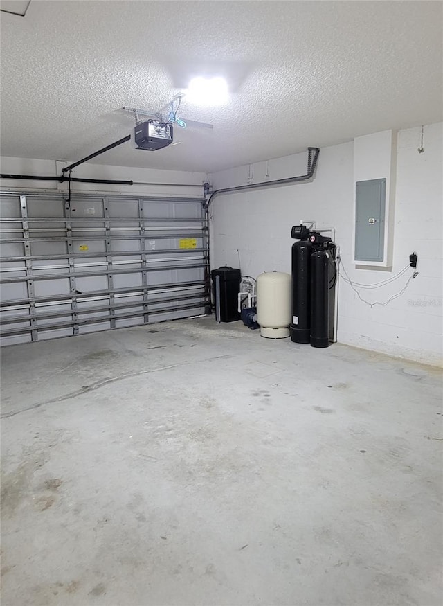 garage with a garage door opener and electric panel