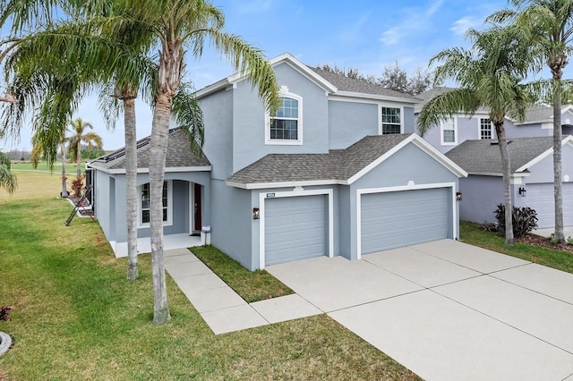 view of front of house with a garage and a front lawn