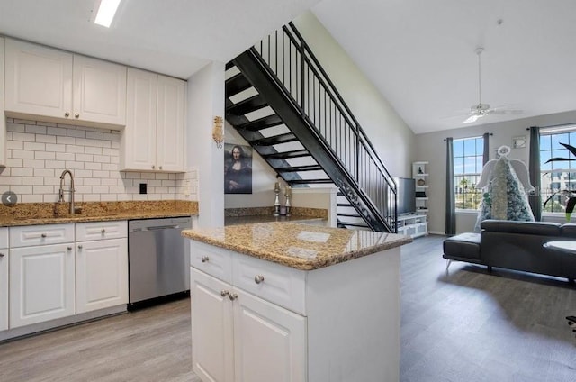 kitchen with white cabinets, sink, dishwasher, and light wood-type flooring