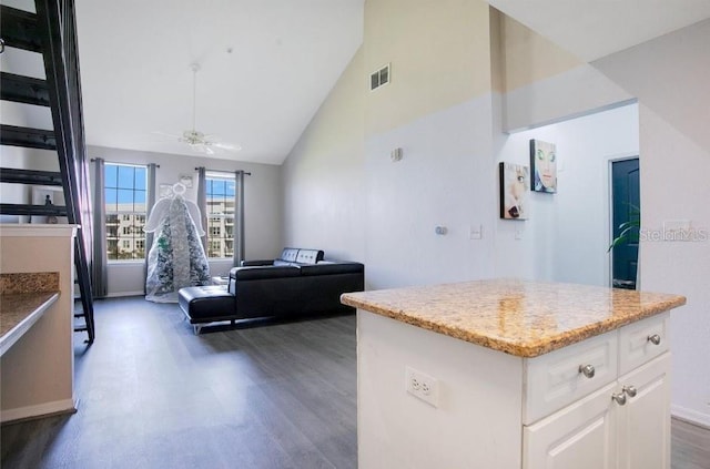 kitchen featuring dark wood-type flooring, a center island, high vaulted ceiling, ceiling fan, and white cabinets