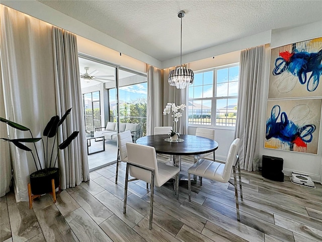 dining area with a chandelier and a textured ceiling