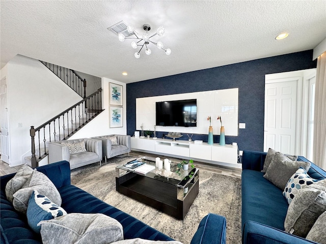 living room featuring a textured ceiling and light hardwood / wood-style flooring