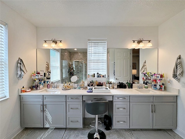 bathroom featuring vanity, an enclosed shower, and a textured ceiling