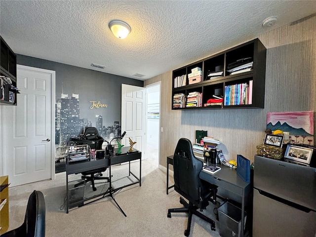 office space featuring light carpet and a textured ceiling