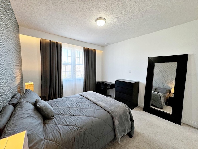 carpeted bedroom featuring a textured ceiling